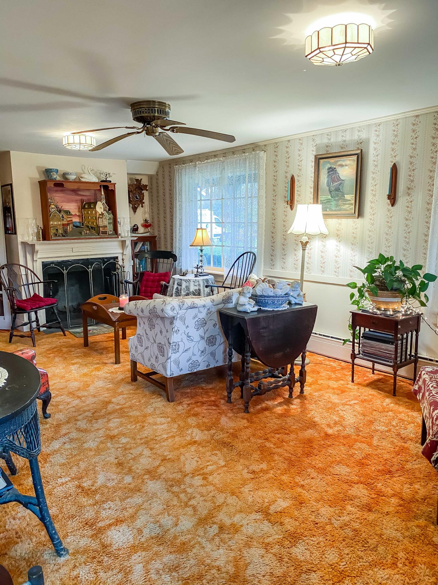 166 Katama Road Edgartown, MA 02539 - Photo 8 of 42 a living room with fireplace furniture and a large window