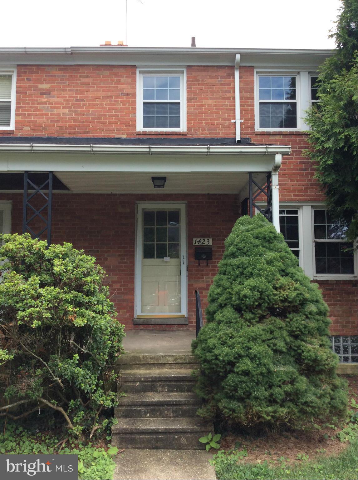 1423 Stonewood Road Baltimore, MD 21239 - Photo 1 of 29 a front view of a house with a garden