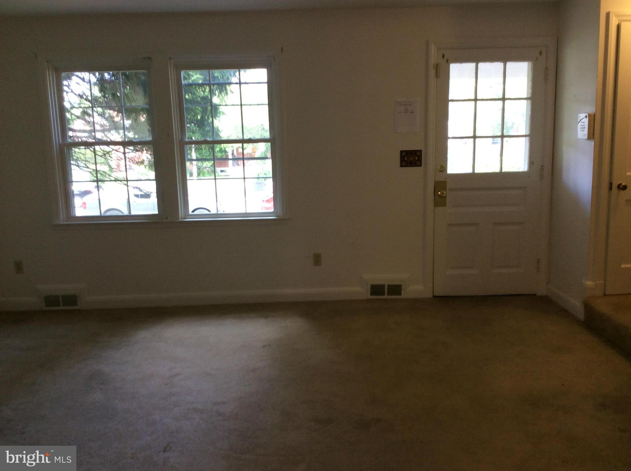 1423 Stonewood Road Baltimore, MD 21239 - Photo 3 of 29 an empty room with a window
