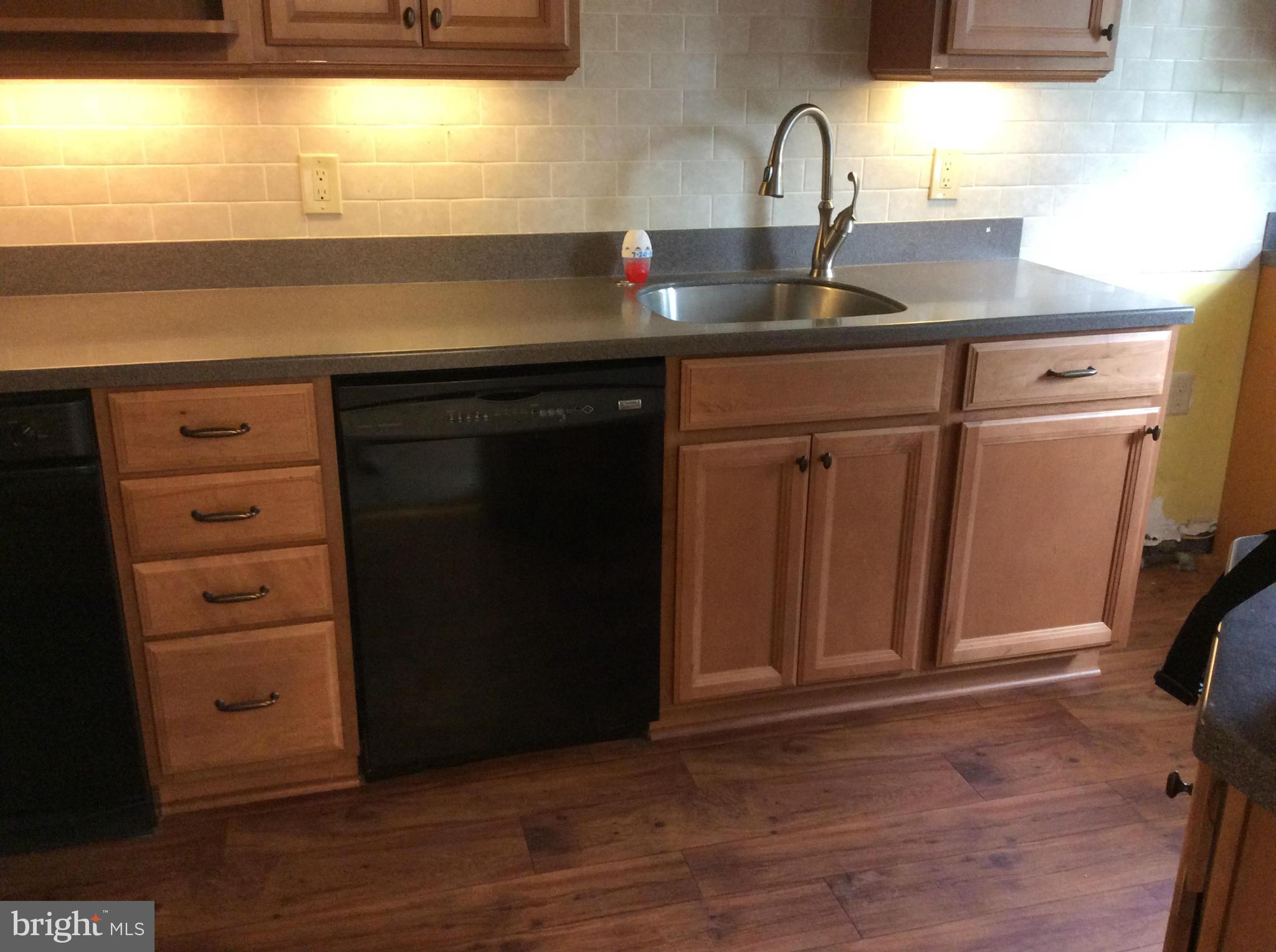 1423 Stonewood Road Baltimore, MD 21239 - Photo 5 of 29 a kitchen with a sink and a window