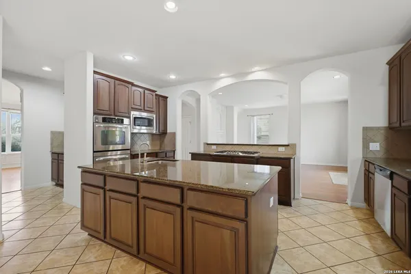 a kitchen with kitchen island granite countertop a sink and counter space