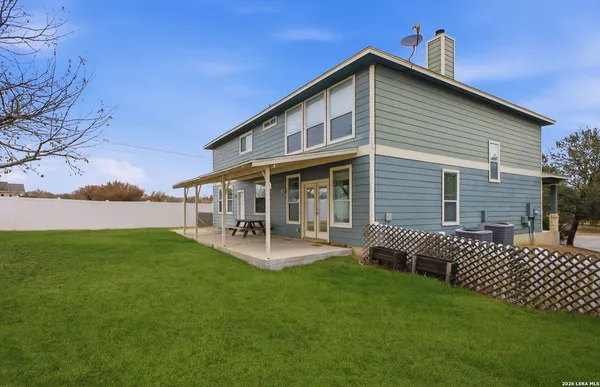 a front view of a house with patio and garden