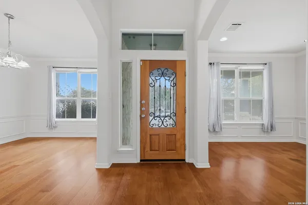 an empty room with wooden floor and a window