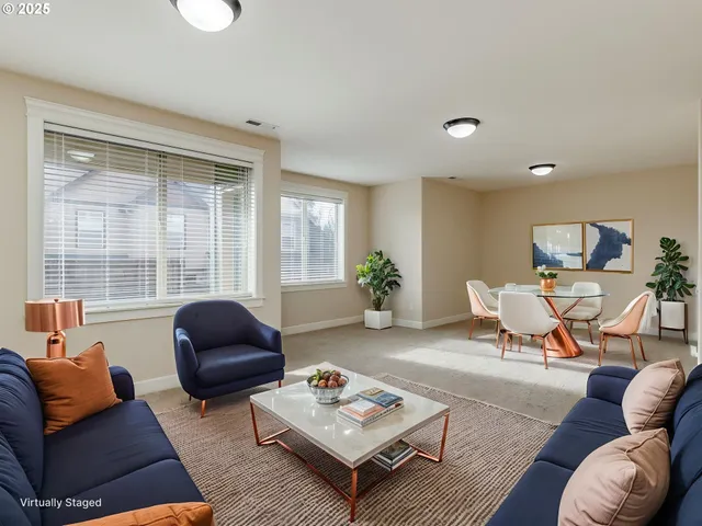 a view of an empty room with a window and a kitchen