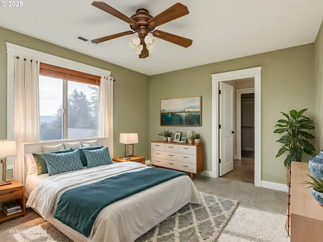 a view of an empty room with window and chandelier fan