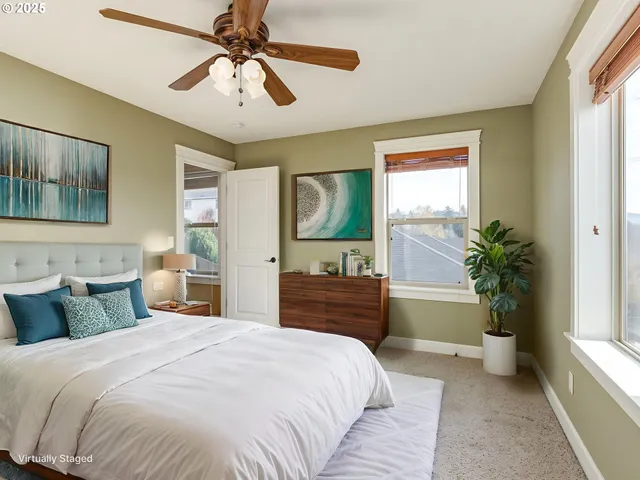a view of empty room with window and chandelier fan