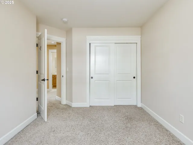 a bedroom with a large bed and a flat screen television