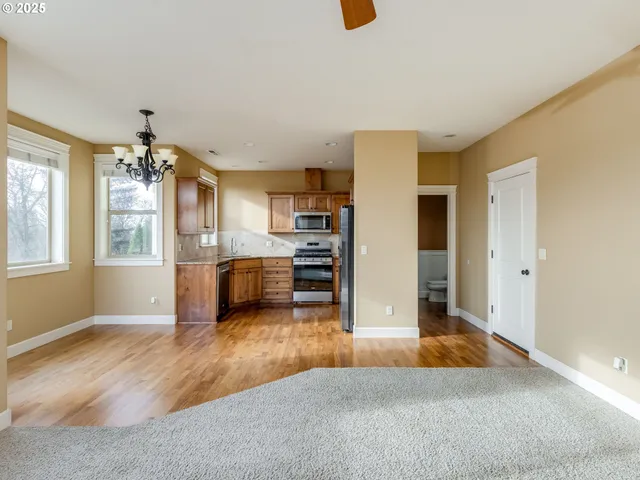 a view of a livingroom with a fireplace and a ceiling fan