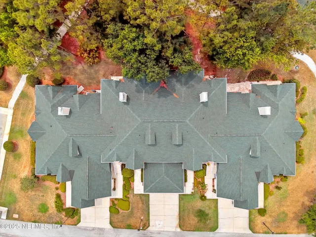 an aerial view of residential houses with outdoor space