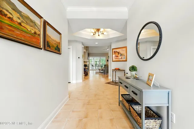 a view of a living room kitchen and entryway