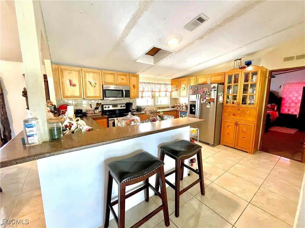 270 G Road LaBelle, FL 33935 - Photo 11 of 14 a living room with lots of furniture and a kitchen view