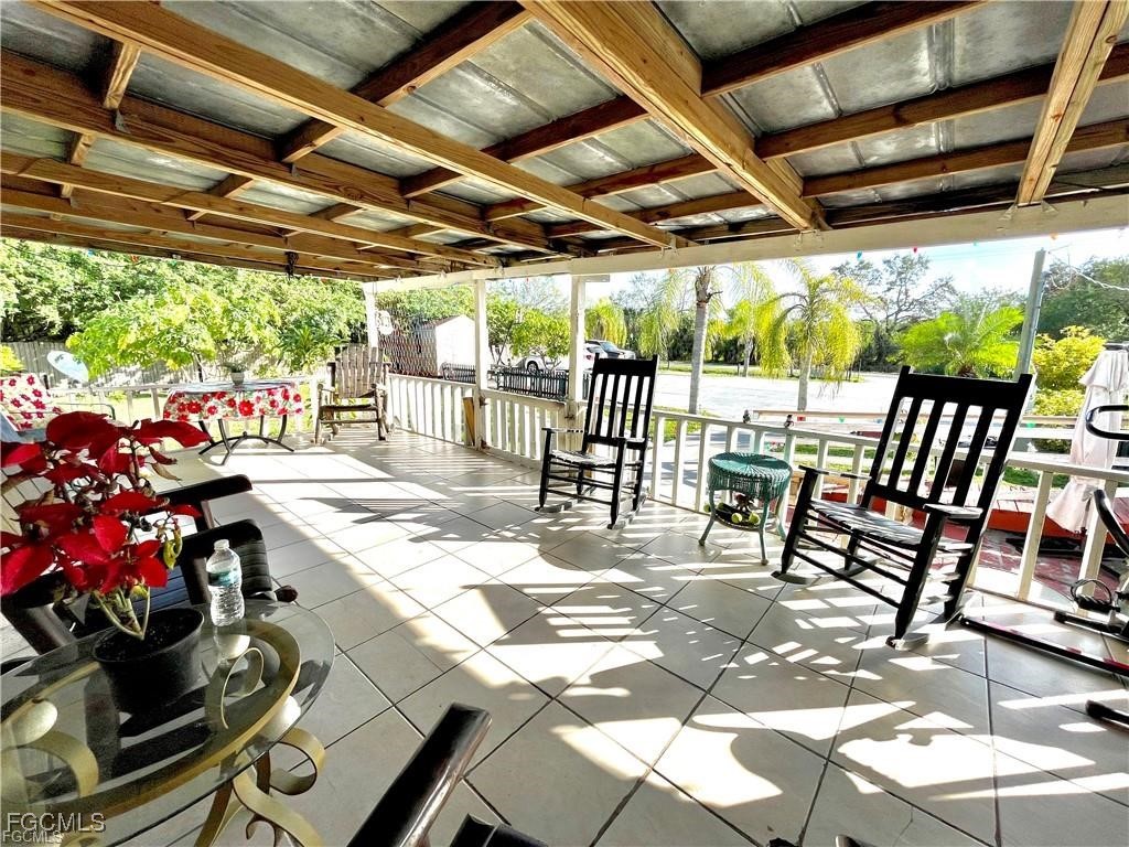 270 G Road LaBelle, FL 33935 - Photo 5 of 14 a patio with glass top table and chairs