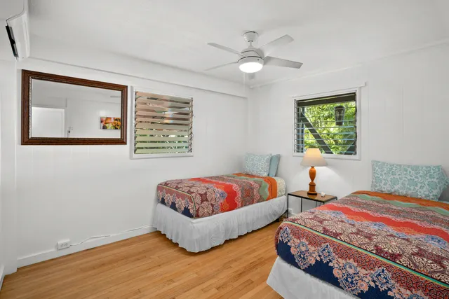 a bedroom with a bed and a lamp on dresser