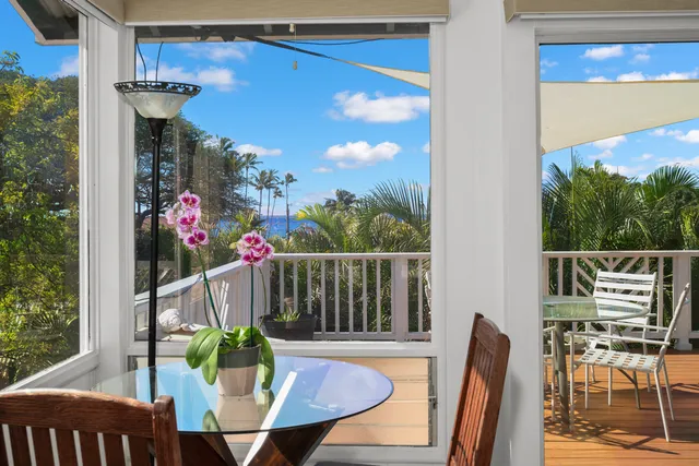 a view of a dining room with furniture large windows and wooden floor