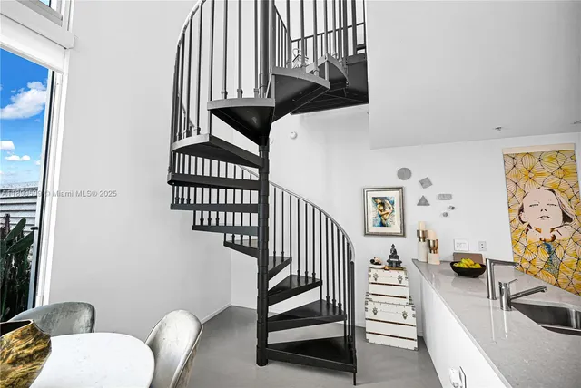 a kitchen with stainless steel appliances granite countertop a sink and a microwave