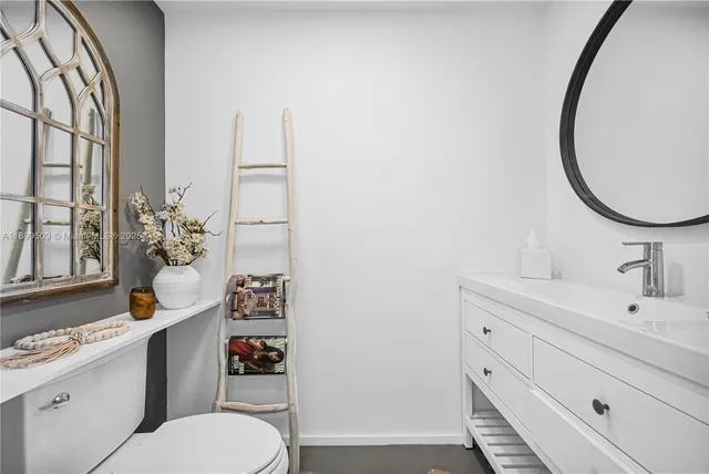 a white toilet sitting next to a bathroom sink