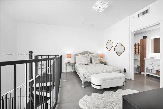 a bedroom with a bed and chair