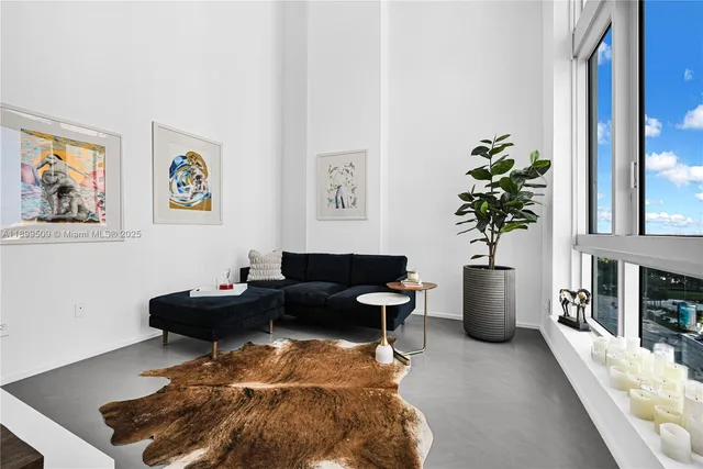 a living room with furniture potted plant and a window