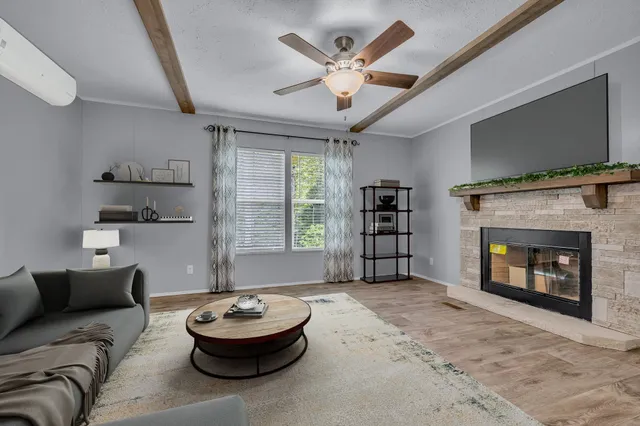 a living room with furniture and a fireplace