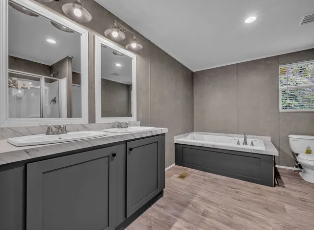 a bathroom with a tub sink and mirror