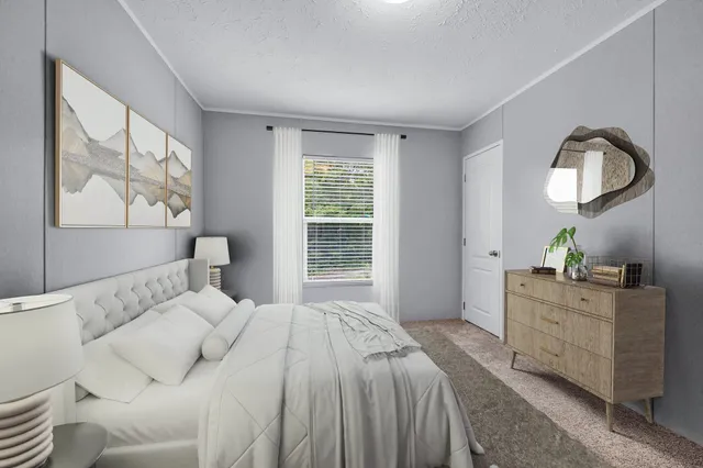 a bedroom with a bed window and a mirror