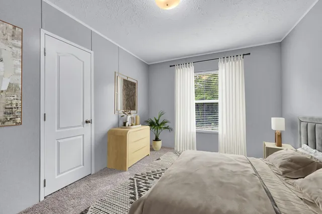 a bedroom with a bed and a window