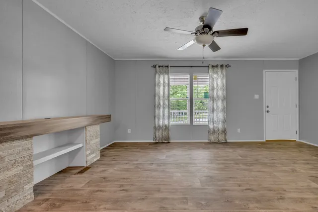 a view of room with window and ceiling fan