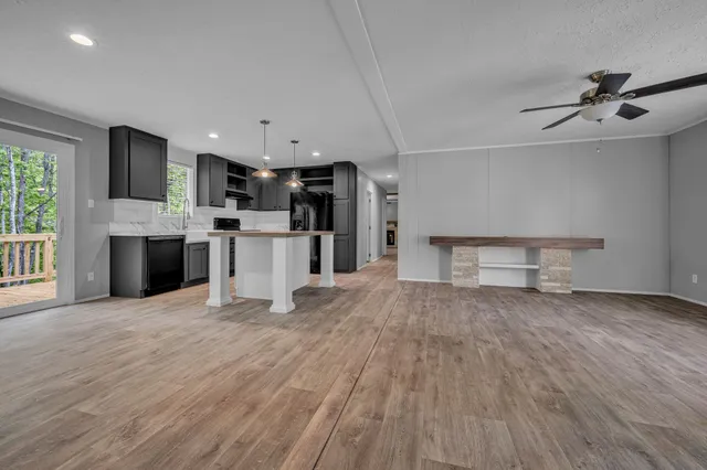 a view of empty room with wooden floor and fireplace