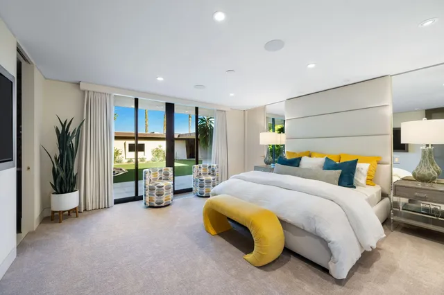 a bedroom with a large bed and a large window