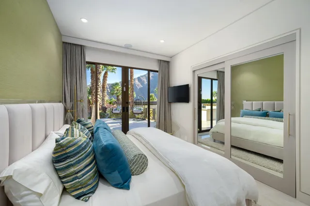 a view of a dining room with furniture a chandelier and wooden floor