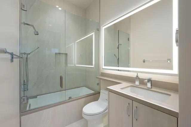 a view of a patio with a table and chairs and potted plants