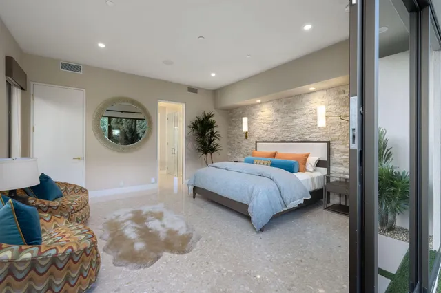 a view of a backyard with plants and patio