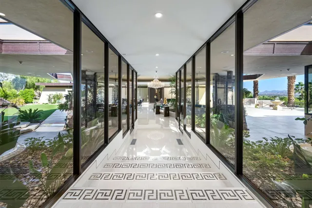 a living room with furniture fireplace and a large window