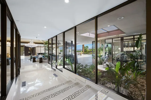 a living room filled with furniture and a chandelier