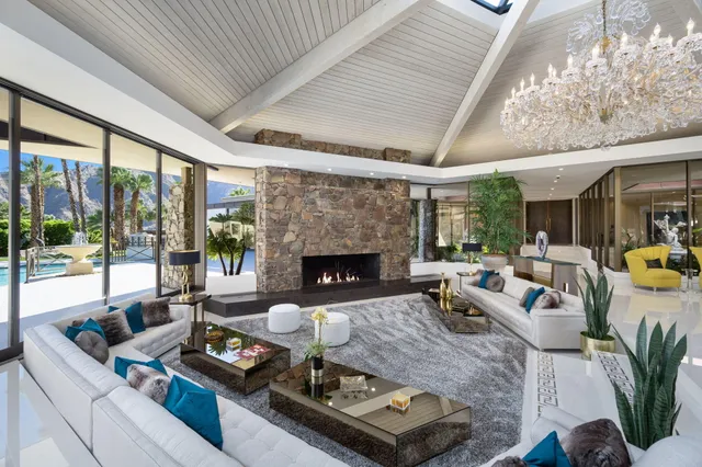 a view of a dining room with furniture wooden floor and garden view