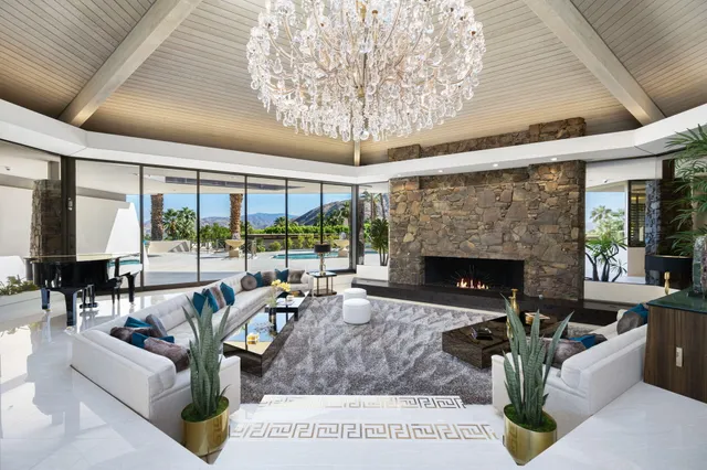 a bedroom with bed and a chandelier