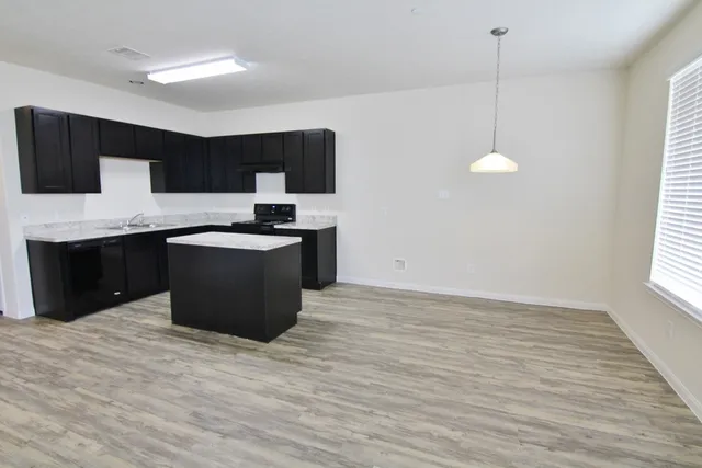 a kitchen with stainless steel appliances granite countertop a sink counter space cabinets and a window