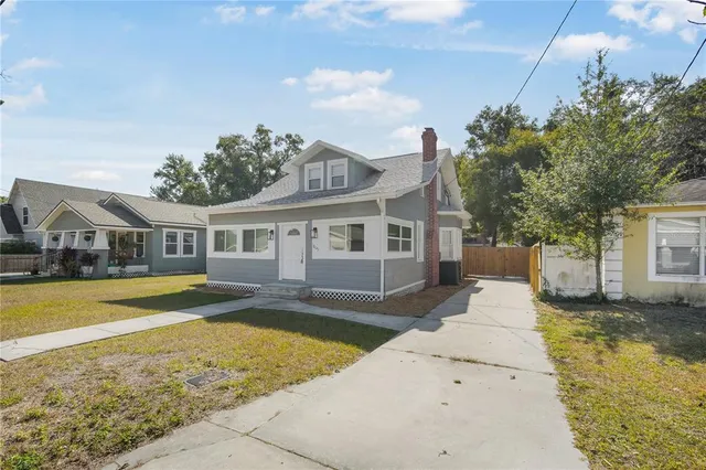 a front view of a house with a yard table and chairs
