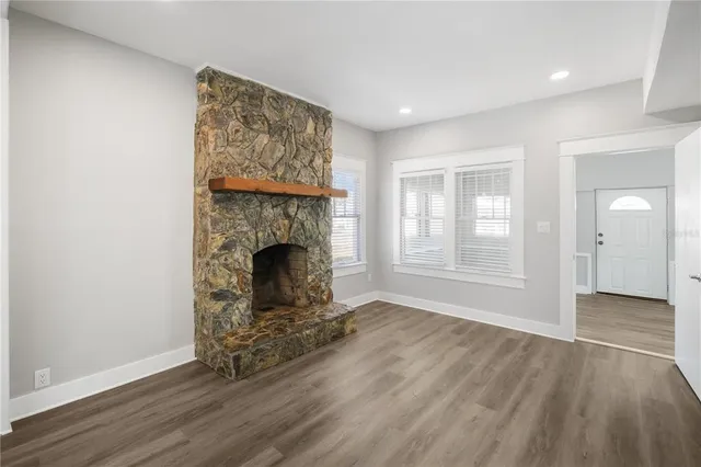 a view of a livingroom with a fireplace and window