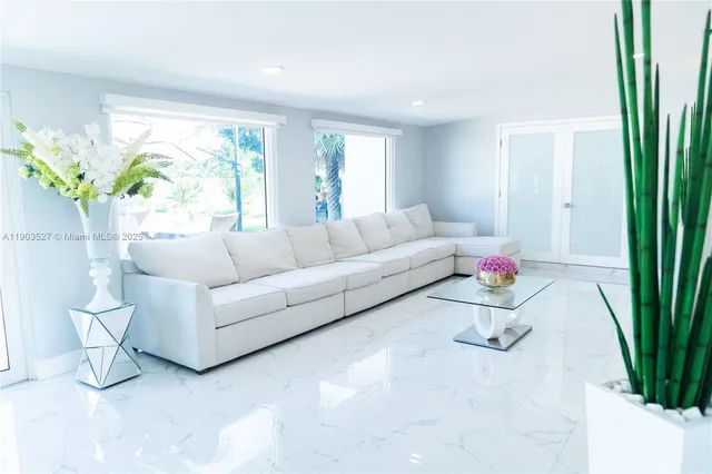 a living room with furniture and a potted plant