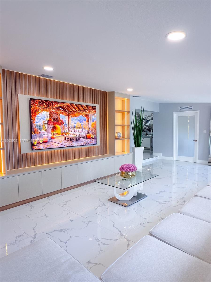 19245 Southwest 188th Street Miami, FL 33187 - Photo 15 of 38 a living room with furniture and a flat screen tv
