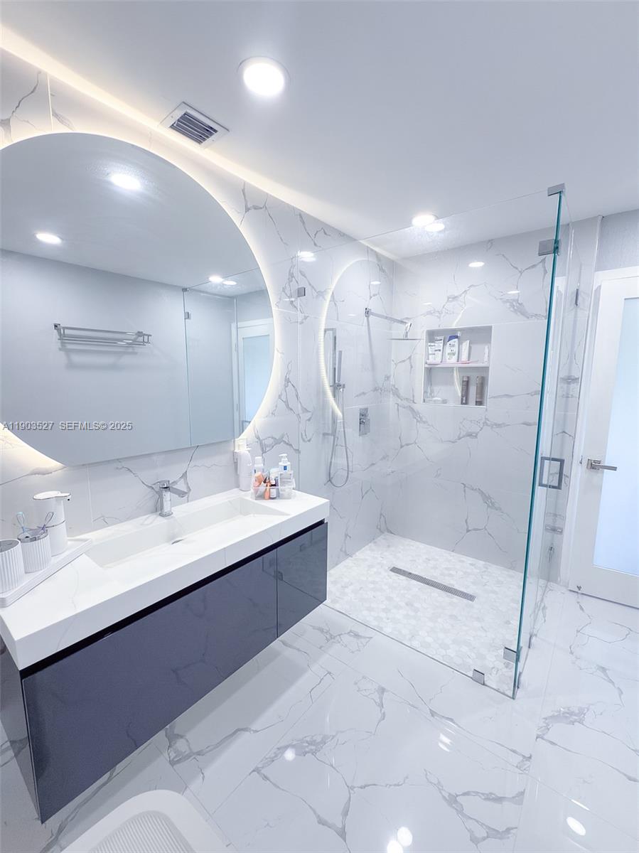 19245 Southwest 188th Street Miami, FL 33187 - Photo 20 of 38 a bathroom with a double vanity sink mirror and shower