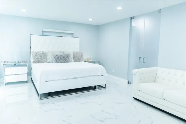 a bedroom with a bed and a couch