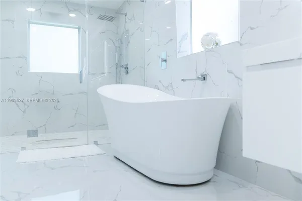 a white bath tub sitting in a bathroom