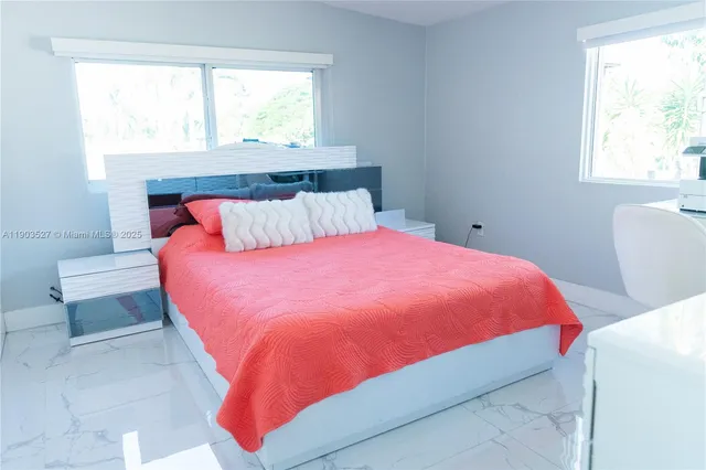 a bed room with a bed and a window