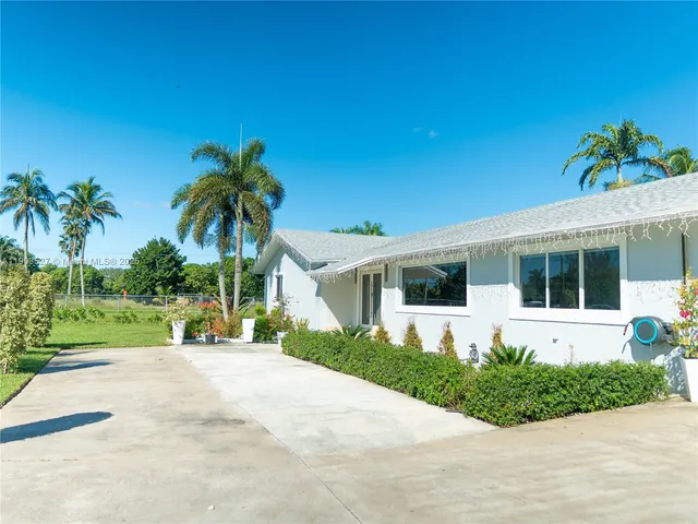 a front view of a house with garden and porch