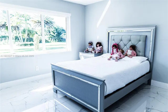 a bedroom with a bed and a large window