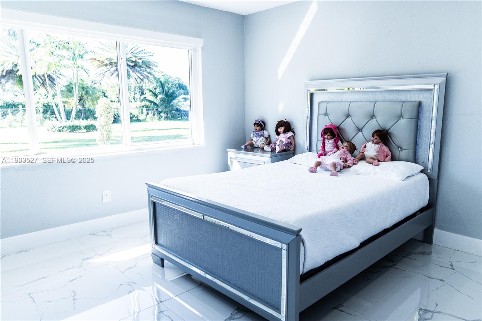 19245 Southwest 188th Street Miami, FL 33187 - Photo 31 of 38 a bedroom with a bed and a large window