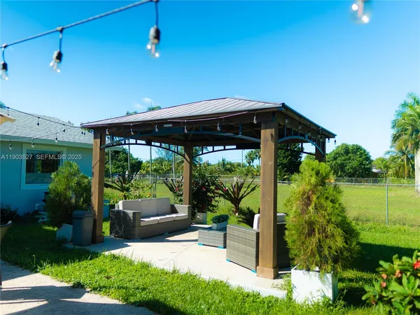a view of a porch with furniture and garden