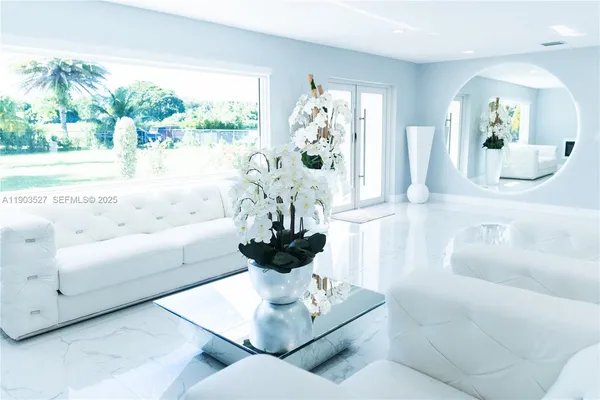 a living room with furniture and a large mirror